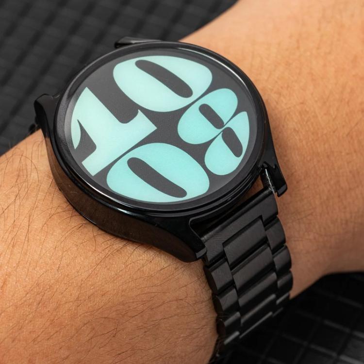 Black stainless steel watch band fitted to a round smartwatch on a wrist