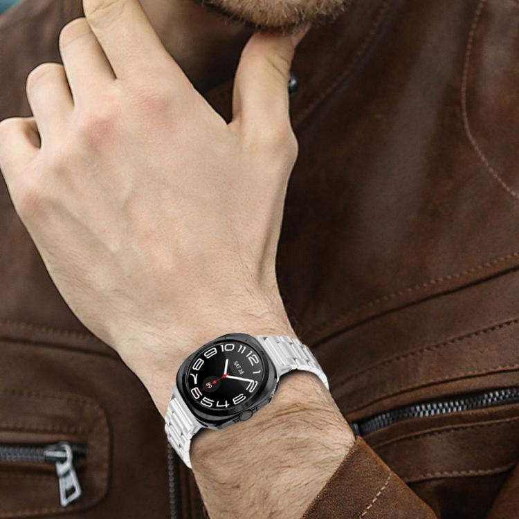 Silver stainless steel watch band worn on a wrist