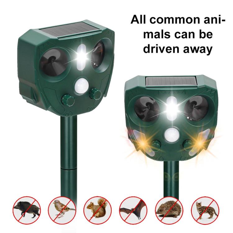 Solar-powered animal repellent with twin speaker lenses and bright central light on dark green base