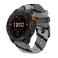Gray and black camouflage silicone watch band with black pin buckle on a Garmin watch.