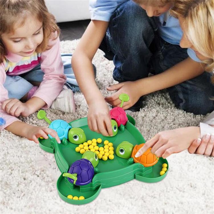 Turtle bean-eating game toy with green tray, colorful turtles, and yellow beads