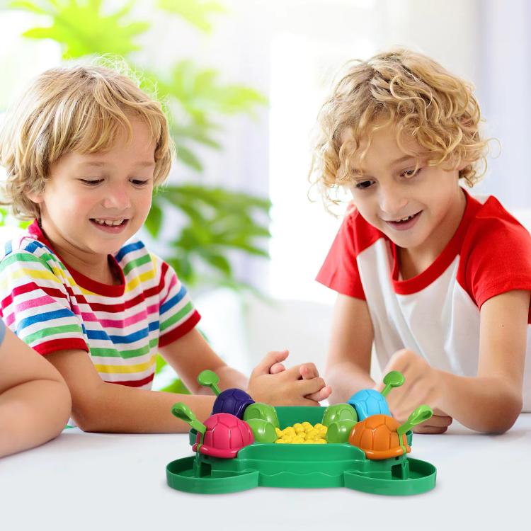 Kids playing with turtle bean-eating game toy on a tabletop
