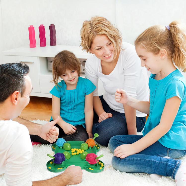 Family playing turtle bean-eating game toy with colorful turtle shells and beads