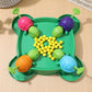 Overhead view of green turtle bean-eating game tray with six shells and yellow beads