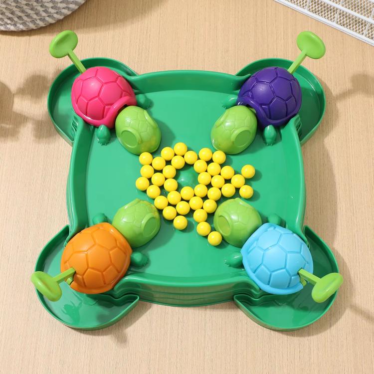 Overhead view of green turtle bean-eating game tray with six shells and yellow beads