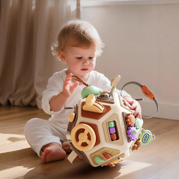 Baby busy board cube toy with many interactive knobs, buttons, and spinning parts