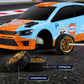Light-blue and orange RC drift rally car front corner with drifting tires