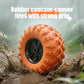 Orange off-road RC stunt car with oversized rubber tires and black wheel rim detail