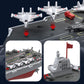 Remote-controlled aircraft carrier toy shown with jets on deck and gray command tower.