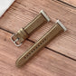 Brown shell-texture watchband with metal buckle and stitched perforation