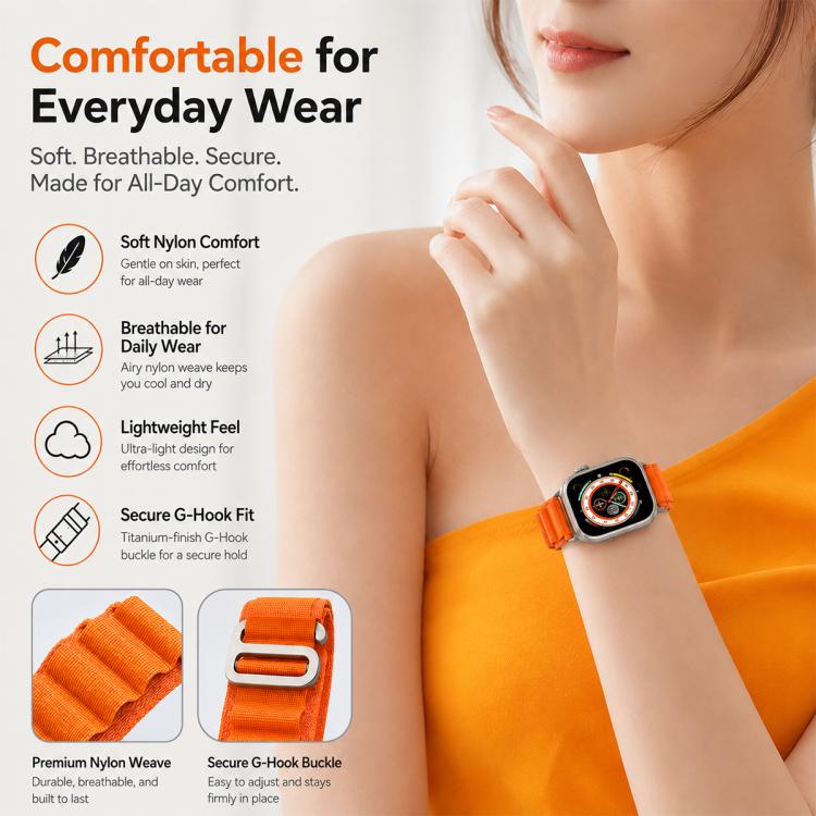 Orange nylon loop watch band worn on a wrist, with fabric and metal hook details