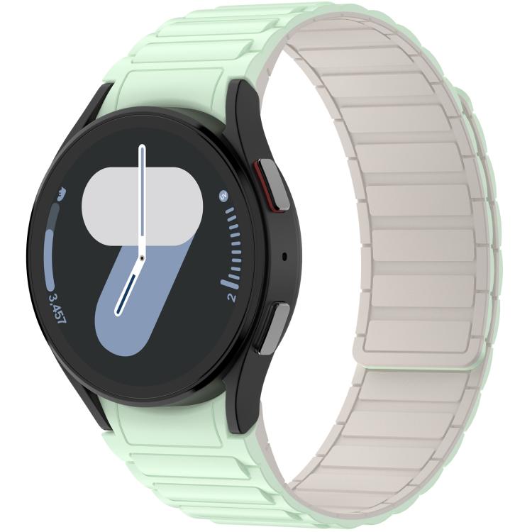 Mint green silicone watch band with light inner panels, fitted to a round smartwatch