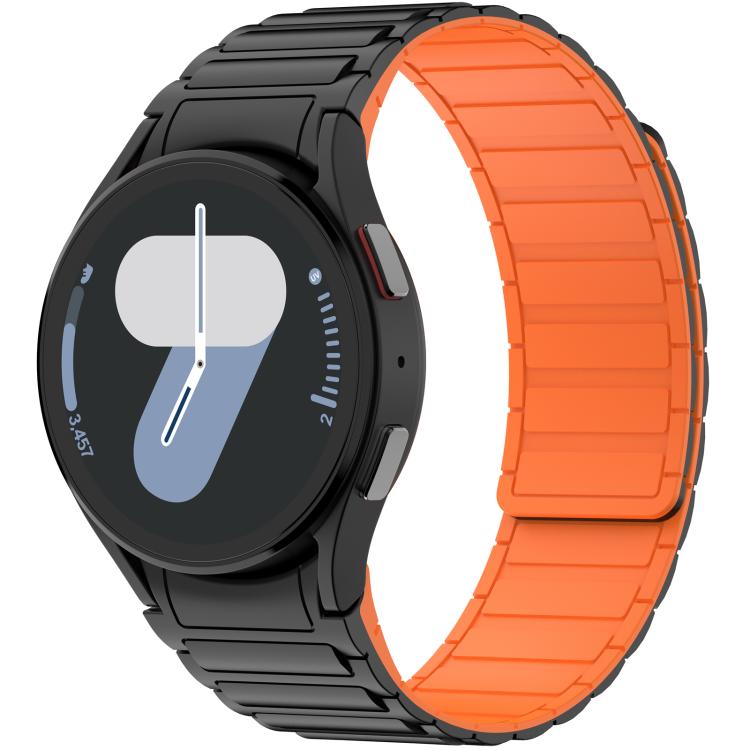 Black silicone watch band with bright orange inner panels, fitted to a round smartwatch