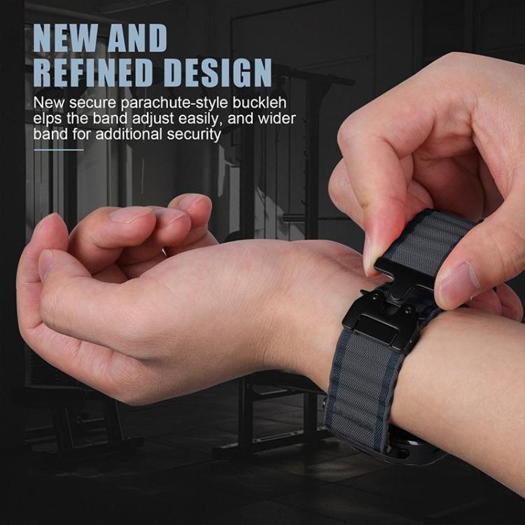 Dark rippled nylon watch band fastened around a wrist with its buckle being adjusted
