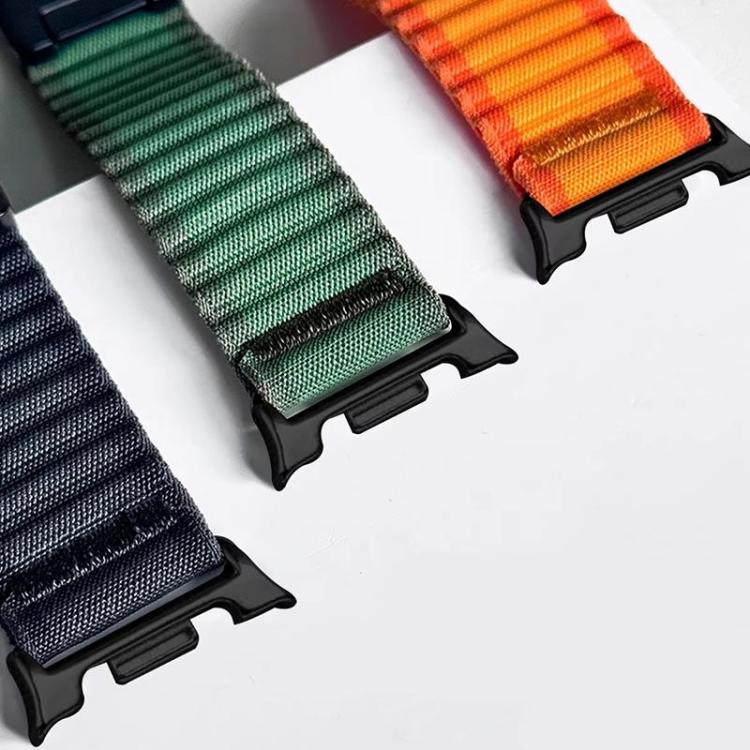 Close-up of navy, green, and orange nylon watch bands with black watch connectors