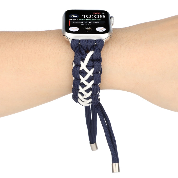 Braided umbrella cord Apple Watch strap on wrist, dark blue with white braid and silver ends