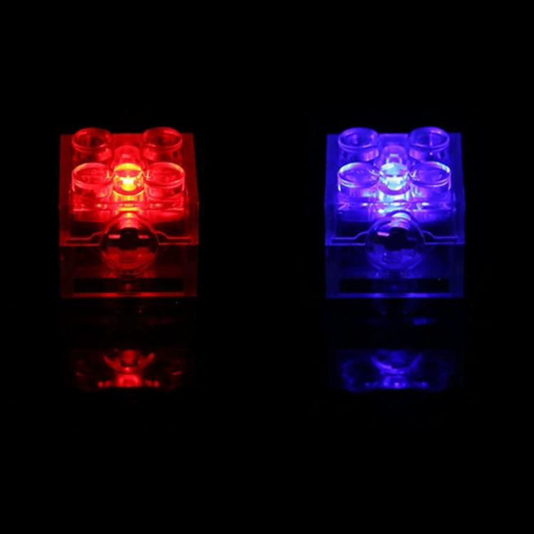 Pair of translucent LED building blocks glowing red and blue