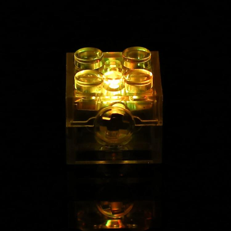 Translucent LED building-block cube glowing yellow-gold