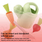 Light green wheat-straw watering can with orange carrot, red radish, and white shovel
