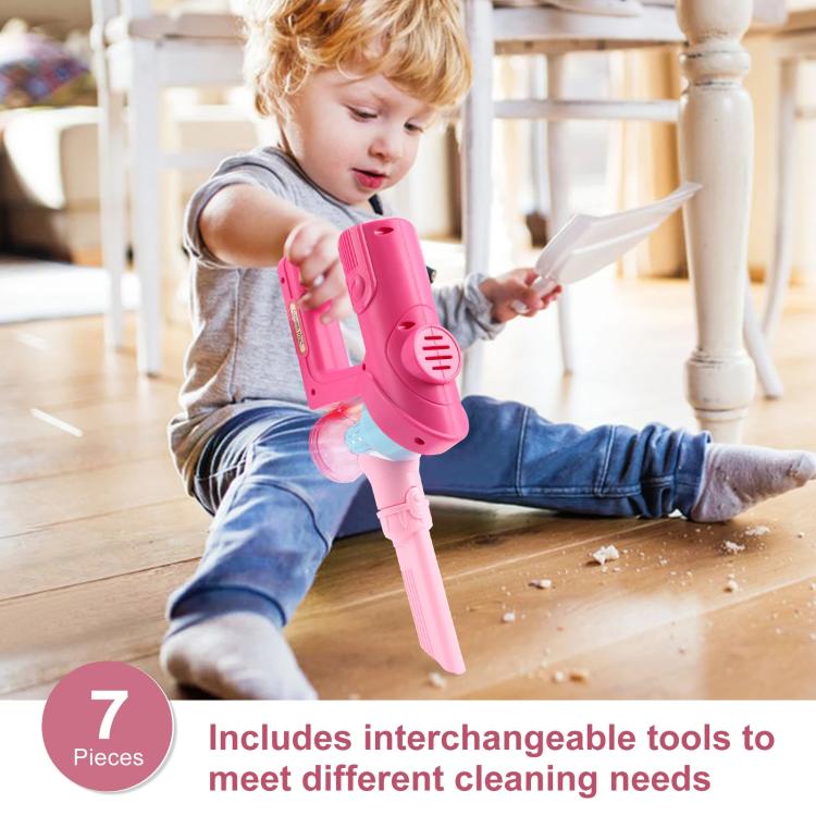 Pink pretend play vacuum cleaner toy held by a child, with simulated suction head