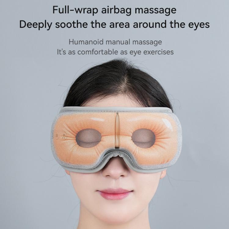Gray full-wrap airbag heat eye massager worn over eyes