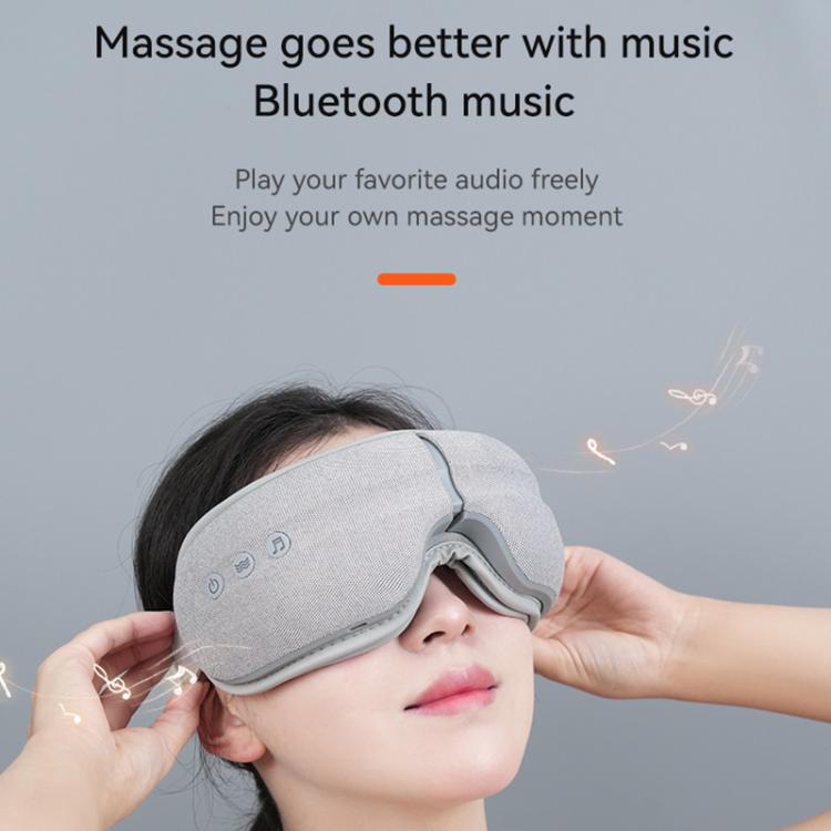 Gray eye massager with Bluetooth-style control on the side of the mask