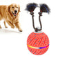 Interactive dog toy ball with rope, orange-red patterned shell and blue trim bristles
