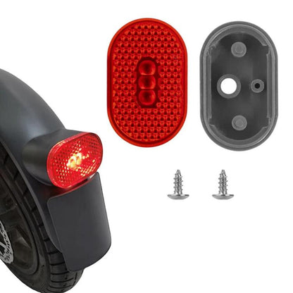 Red taillight lens and black housing with mounting screws for electric scooter cover