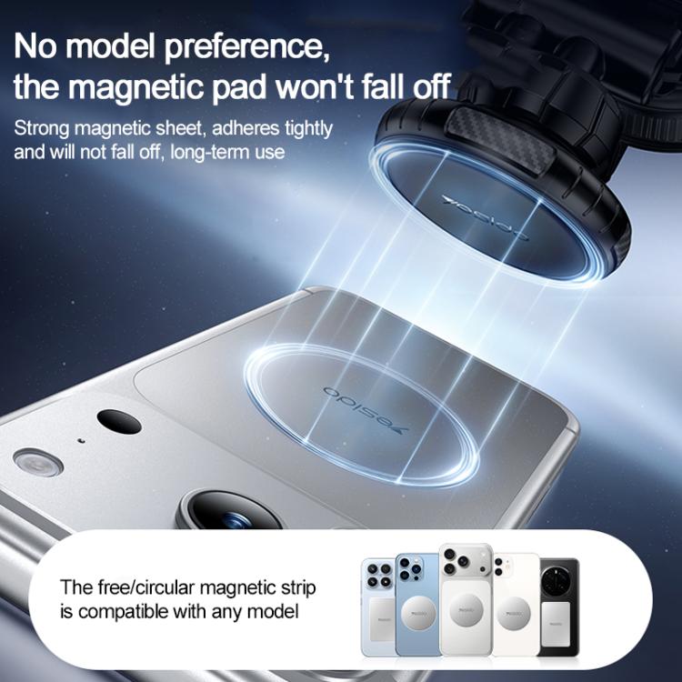 Circular magnetic pad on a black car phone holder near a phone back