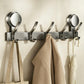No-drill suction cup hook rack with metal rail, multiple curved hooks, and coat hangers