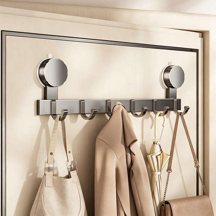 No-drill vacuum suction cup hook rack with chrome hooks holding coats, umbrella, and handbag