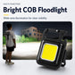Black COB floodlight-style keychain light with yellow panel and side handle