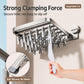 Wall-mounted suction cup drying rack with clothespins and a hand holding a fabric item