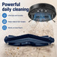 Robot vacuum with black roller brush releasing dust particles on hardwood flooring