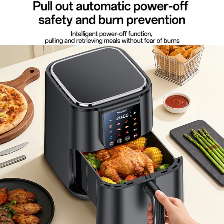 Black 6L air fryer with basket pulled out and roasted chicken inside