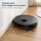 Robot vacuum edge-sweeping with side brushes on wood floor near debris