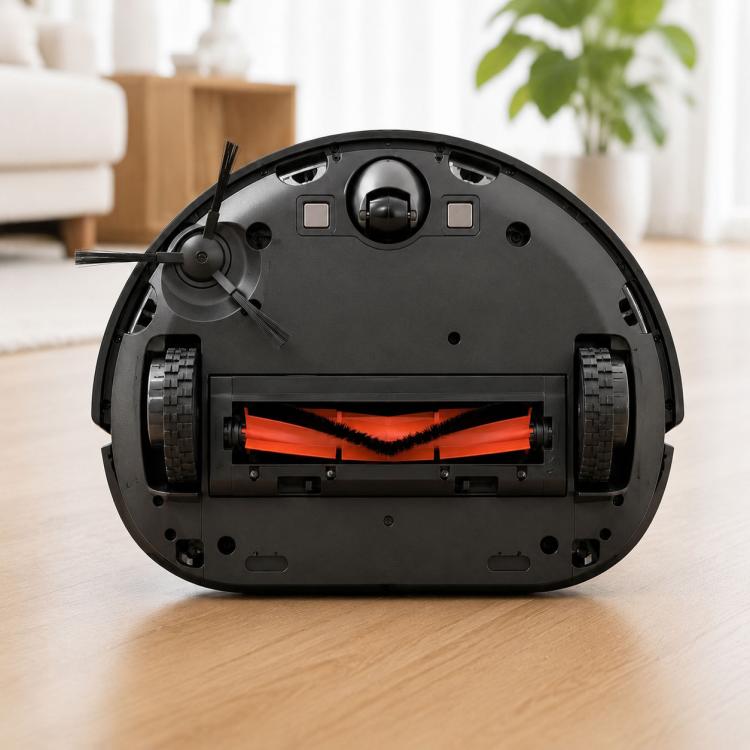 Robot vacuum underside with orange main brush and black bristles installed