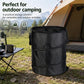 Black folding camping storage bucket with top rim and side handles on outdoor ground