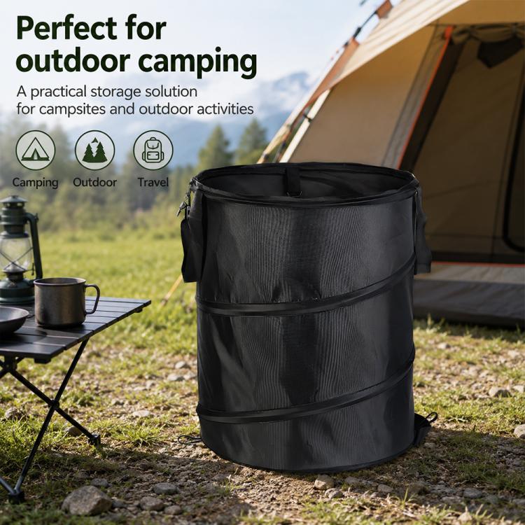 Black folding camping storage bucket with top rim and side handles on outdoor ground