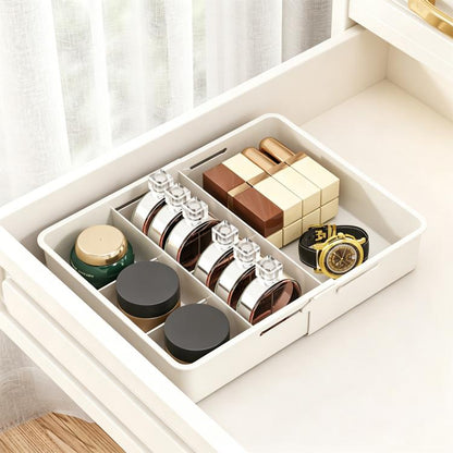 White divided drawer storage box with multiple compartments for small items and bottles