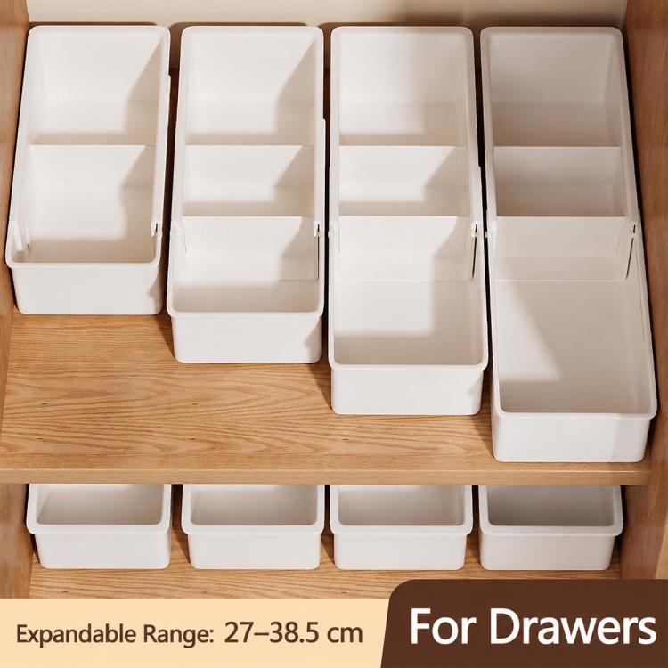 Set of white fold-out drawer bins for organizing small items on a wooden dresser
