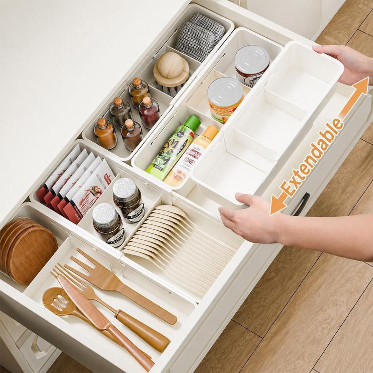 White drawer organizer with removable divider sections for jars, bottles, and utensils