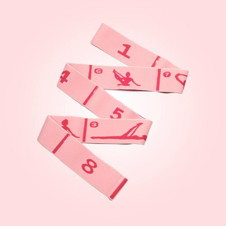 Peach/pink yoga resistance band with numbered segments and red printed exercise poses