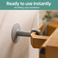 Grey suction cup door handle bumper pad attached to a wall near a wooden door handle