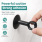 Black suction cup door handle bumper pad attached to a smooth wall surface