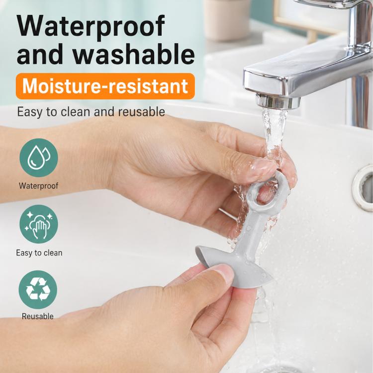 Grey waterproof and washable suction cup door handle bumper pad being rinsed with water
