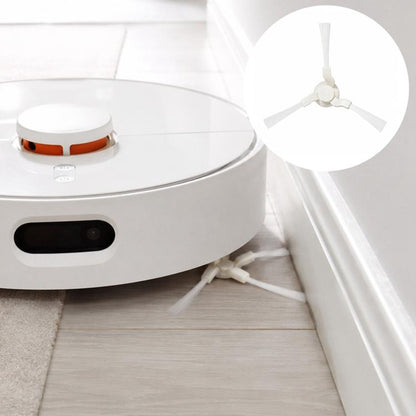 Robot vacuum with triangular side brush replacement piece installed near wall edge