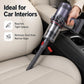 Long flat crevice tool cleaning car seat gap, dark gray head with red nozzle insert.