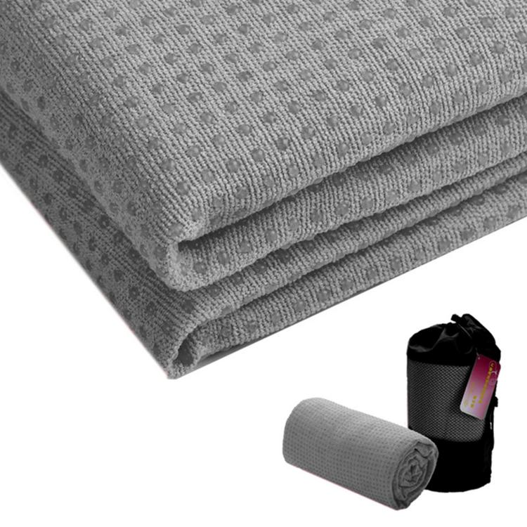 Grey yoga towel, neatly folded with textured non-slip grip surface.