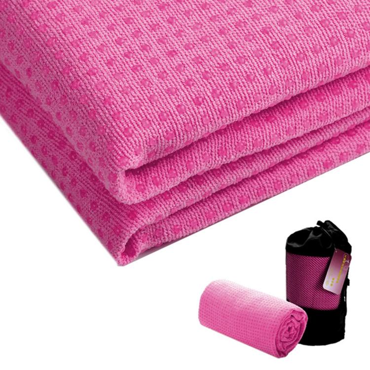 Rose pink yoga towel, folded and rolled end showing soft textured non-slip surface.